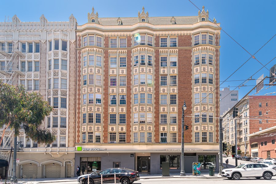 A large, multi-story building with a sign that reads 